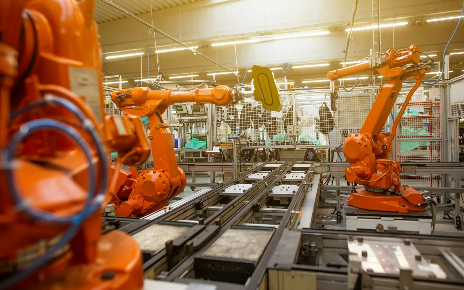 Orange industrial machines in a factory.